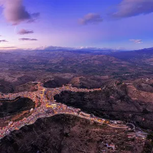 Panoramic aerial view of the man-shaped (or star-shaped) illuminated village of Centuripe with Etna volcano, Centuripe, Enna province, Sicily, Italy Panoramic aerial view of the man-shaped (or star-shaped) illuminated village of Centuripe with Etna volcano, Centuripe, Enna province, Sicily, Italy