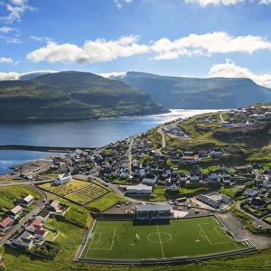Panoramic aerial view of soccer field in the village of Eidi, Eysturoy island, Faroe