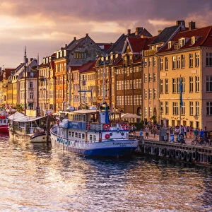 Panoramic view of Nyhavn water canal at sunset in Copenhagen, Denmark