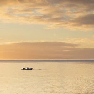 People kayaking at sunset, Leleuvia Island, Lomaiviti Islands, Fiji