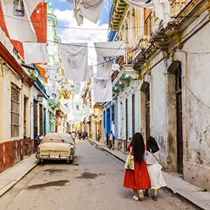 People walking in a narrow street in La Habana Vieja (Old Town), Havana, Cuba