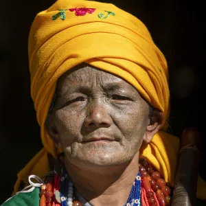 Portrait of a woman with traditional tattooed face in Mindat, Chin State, Myanmar