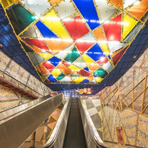 Portugal, Lisbon. Escalators and the colorful decorations at Olaias subway station