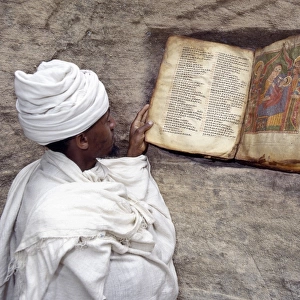 A Priest of the Ethiopian Orthodox Church reads a very old
