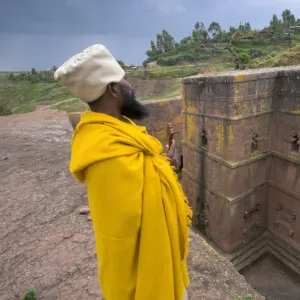 Priest outside the Sunken Rock Hewn church of Bet Giyorgis