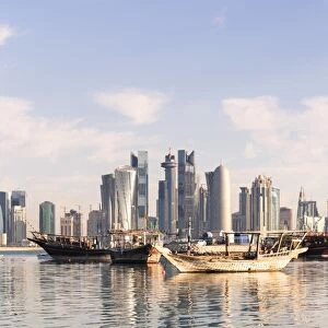 Qatar, Doha. Cityscape with fishing boats in the foreground