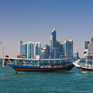 Qatar, Doha, Dhows on Doha Bay with West Bay skyscrapers