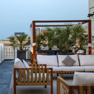 Qatar, Doha, Rooftop terrace of boutiqe hotel at Souq Waqif with Fanar Qatar Islamic