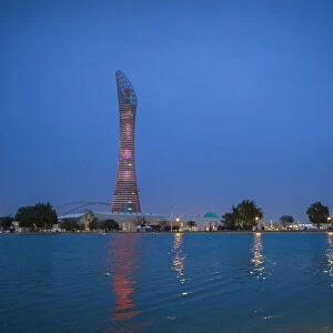 Qatar, Doha, The Torch Hotel reflecting in the lake in Aspire Park