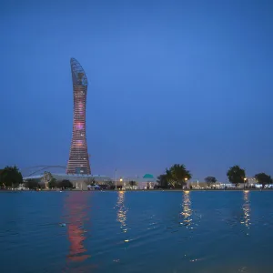 Qatar, Doha, The Torch Hotel reflecting in the lake in Aspire Park