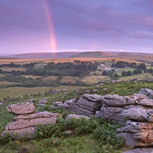 Rainbow over Dartmoor at dawn, Holwell Tor, Dartmoor, Devon, England. Summer (August)