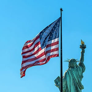 Rear side of Statue of Liberty with US flag, Liberty Island, New York, USA