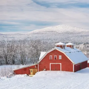 Red barn at foot of mountain in winter, Northeast Kingdom, Guildhall, Vermont, USA Red barn at foot of mountain in winter, Northeast Kingdom, Guildhall, Vermont, USA