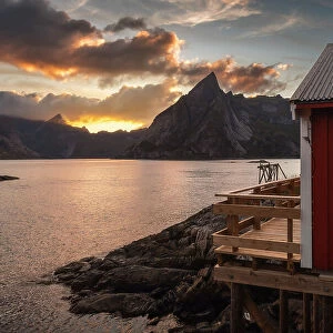 A red rorbu in Hamnoy catching the last light of the day on a colorful summer sunset. Lofoten Islands, Norway