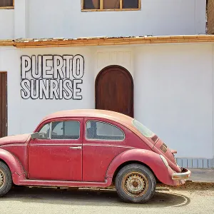 A red Volkswagen Beetle in front of a house in Puerto Eten, Chiclayo, Lambayeque, Peru