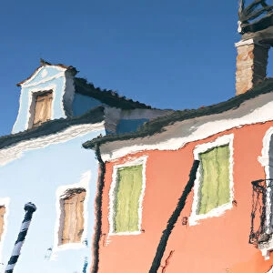 Reflection of colourful buildings in a canal on Burano Island, Burano, Venice, Italy