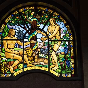 Representations of Adam and Eve on stained glass windows inside Holy Trinity Cathedral