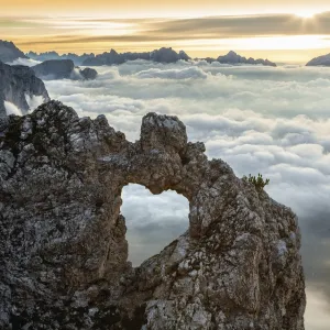 A rocks heart, on a clouds sea, between rock walls. (Dolomites, Italy)