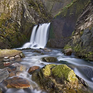 Rocks, stream and waterfall at Spekes Mill Mouth beach in North Devon, England. Spring