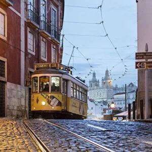 Romantic atmosphere in the old streets of Alfama with the castle in the background