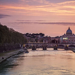 A romantic sunset on Tiber River with bridge Umberto I and Basilica di San Pietro