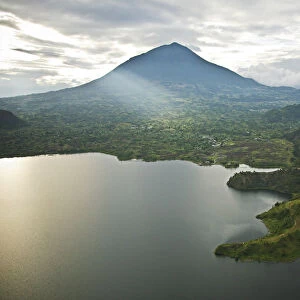 Rwanda. Lake Burero reaches out underneath the volcanoes