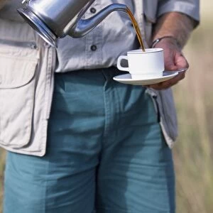 Safari guide pours coffee, Elsas Kopje