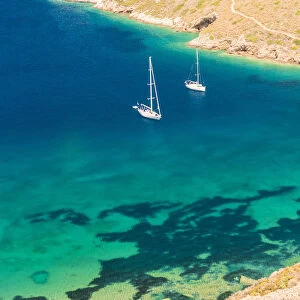 Sailing boats floating on the turquoise aegean sea at Porto Kagio, Laconia region