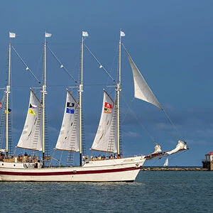 Sailing ship with Chicago Harbor Lighthouse in the backdrop, Chicago, Illinois, USA