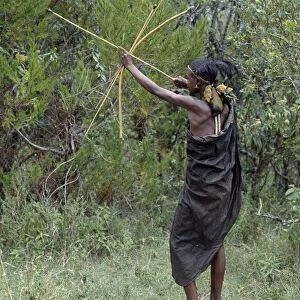 A Samburu initiate takes aim at a bird with a blunt arrow