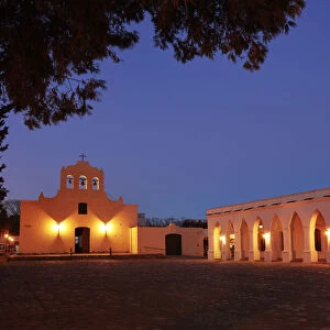 The "San Jose Church" and the arches of the Archaeological Museum Pio Pablo Diaz illuminated at night, Cachi, Salta province, Argentina