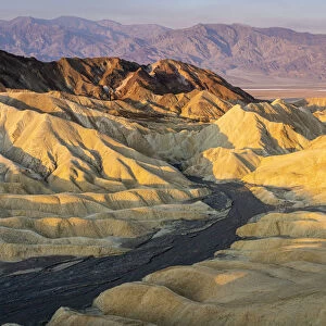 Scenic view of natural rock formations at Zabriskie Point during sunrise