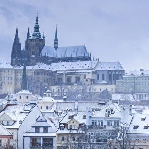 Scenic view of Prague Castle and snow-covered roofs in winter, Prague, Bohemia
