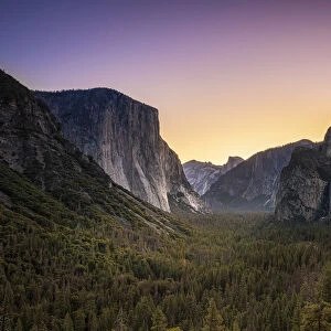 Scenic view of trees by rocky mountains at Tunnel View before sunrise