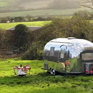 Shiny Airstream caravan parked near Lulworth Cove, Dorset, UK