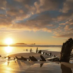 Shipwreck of the Helvetia on the sandy shores of Rhossili Bay at sunset, Gower Peninsula, South Wales, UK. Winter (January) 2020 Shipwreck of the Helvetia on the sandy shores of Rhossili Bay at sunset, Gower Peninsula, South Wales, UK. Winter (January) 2020