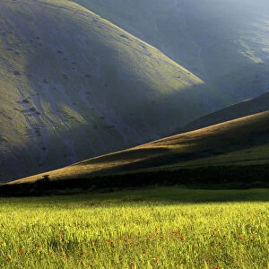 Sibillini national park, Umbria, Italy. Ray of light between mountain ridges, with fields