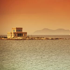 Sicily, Italy, Western Europe; A villa at sea with the Egadi islands visible in the background in the farthest part of the