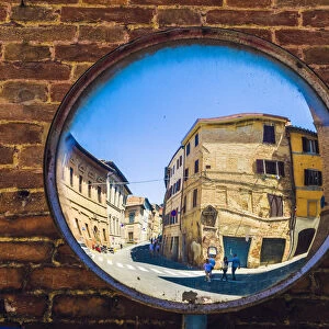 Siena, Tuscany, Italy. Two people reflected in a street mirror