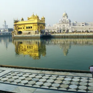 A Sikh pilgrim pauses for reflection by Amrit Sarovar