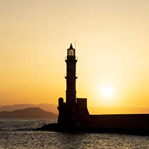 Silhouette of Chania old lighthouse at sunset, Crete island, Greece