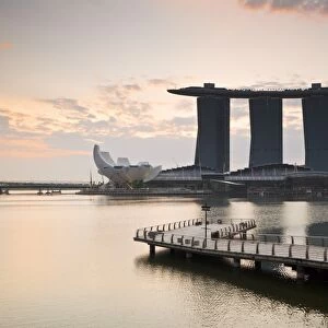 Singapore, Singapore, Marina Bay. The Merlion Statue at dawn, with the Marina Bay Sands in the background