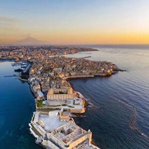 Siracusa, Sicily. Aerial view of Ortigia island at sunrise with Etna mountain in the