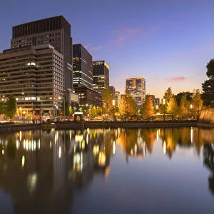 Skyscrapers of Marunouchi and moat of Imperial Palace at dusk, Tokyo, Japan