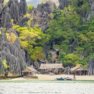 Small native village of thatched huts on the coast of Coron Island, Coron, Palawan