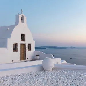 Small traditional Greek whitewashed church at dawn, with caldera view, Oia, Santorini, Cyclades Islands, Greece, Europe