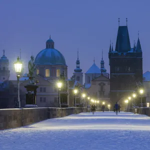 Snow-covered Charles Bridge at twilight in winter, Prague, Bohemia, Czech Republic