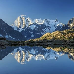 Snowy peaks of Dent Du Geant and Grandes Jorasses are reflected in Lac Blanc, Haute Savoie