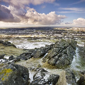 Sourton Tor backed by snow dusted countryside, Dartmoor National Park, Devon, England