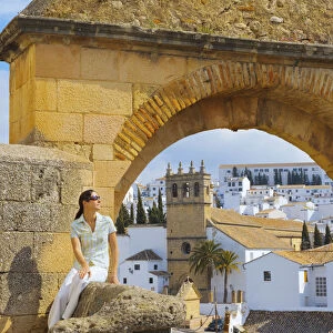 Spain, Andalucia, Malaga Province, Ronda, Felipe V Gate, Woman sitting besite gate (MR)